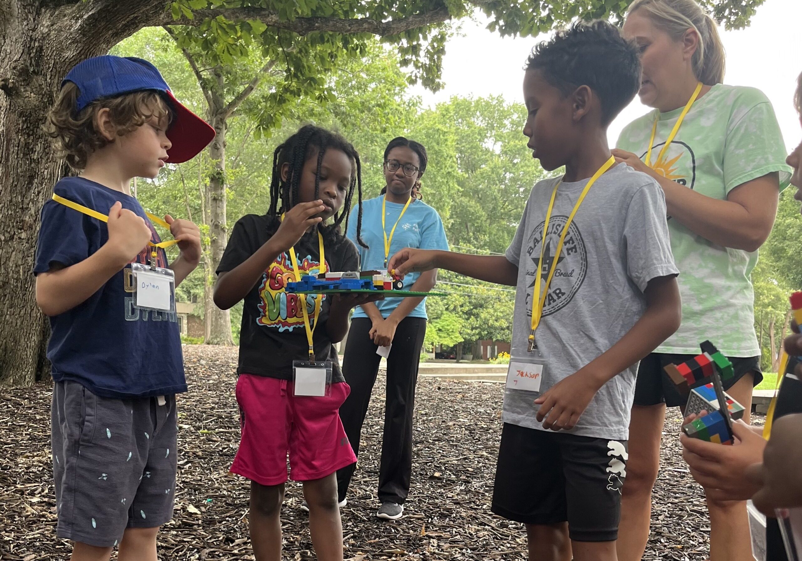 Youth engaged in an outdoor STEAM challenge.
