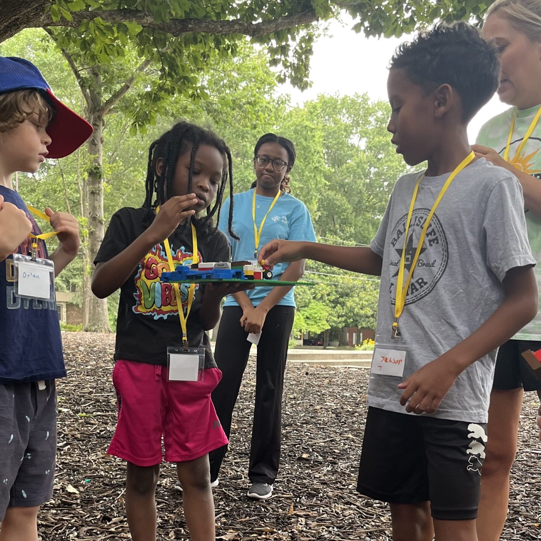 Youth engaged in an outdoor STEAM challenge.
